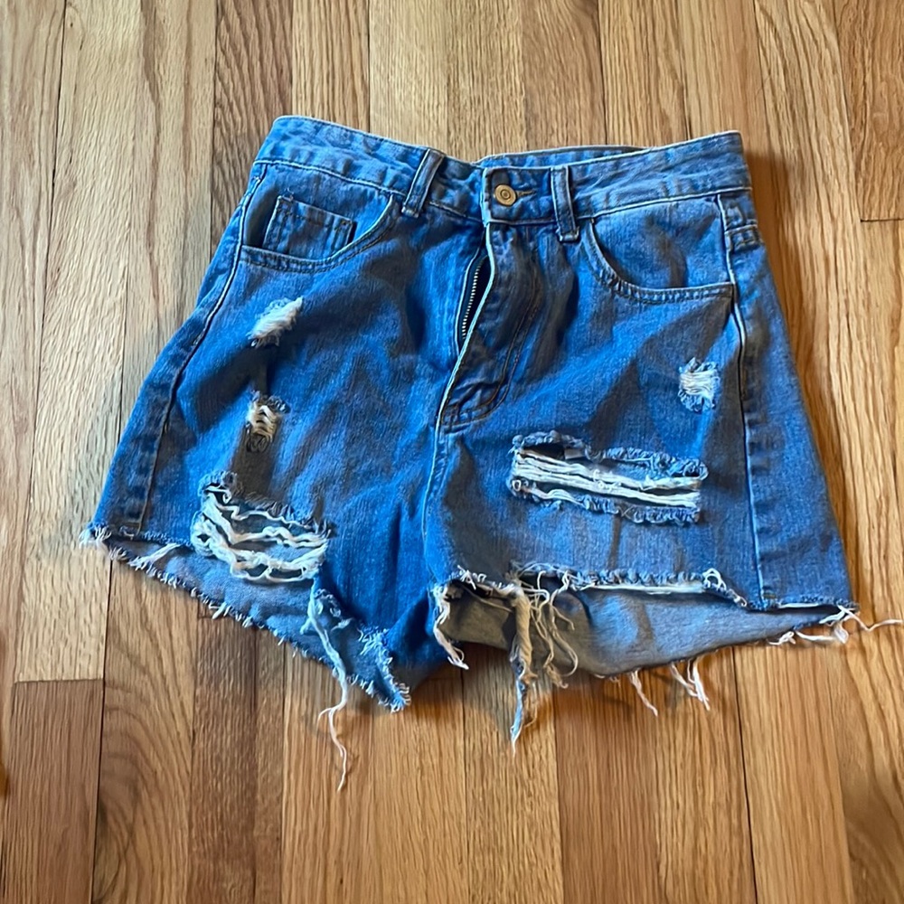 these are darker blue jean shorts, with multiple rips.